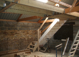 Stairs up to the 1st floor where the grain is stored on palettes.