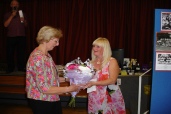 Janet (Sivell) Hicks presenting bouquet of flowers to Shirley (Lubbock) Gibson whose birthday was the same as Vi (Mitchell) Sivell