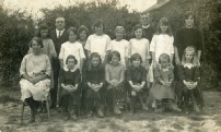 Foulness Church of England School Girls 1926 *BACK ROW* 1 Vera Bird 2 Headmaster Mr Edgar Miskin 3 Gladys Nicholls 4 Mary Rippingale 5 Anne Webb 6 Edith Willsmer 7 ? Phylis Perry 8 Rev Stanton 9 Maria Cripps 10 Eva Hume *FRONT ROW* 1 Grace Bush (worked for Rev Stanton) 2 