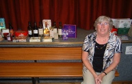 Doris (Chapman) Bracci beside the many raffle prizes