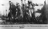 Floods 1953 Great Wakering - Stretcher party carries Mrs Hobbs from her inundated home across the fields to a waiting ambulance
